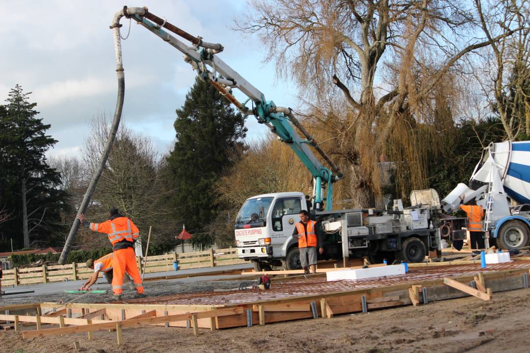 Workers building a concrete driveway